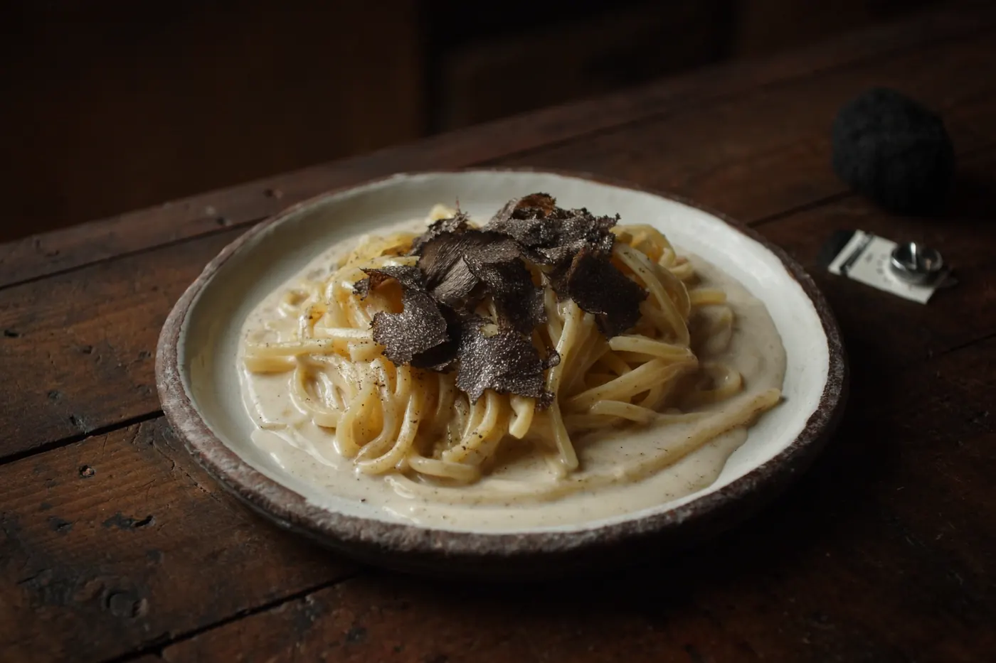 Handmade Istrian fuži pasta in cream sauce under freshly shaved black truffle